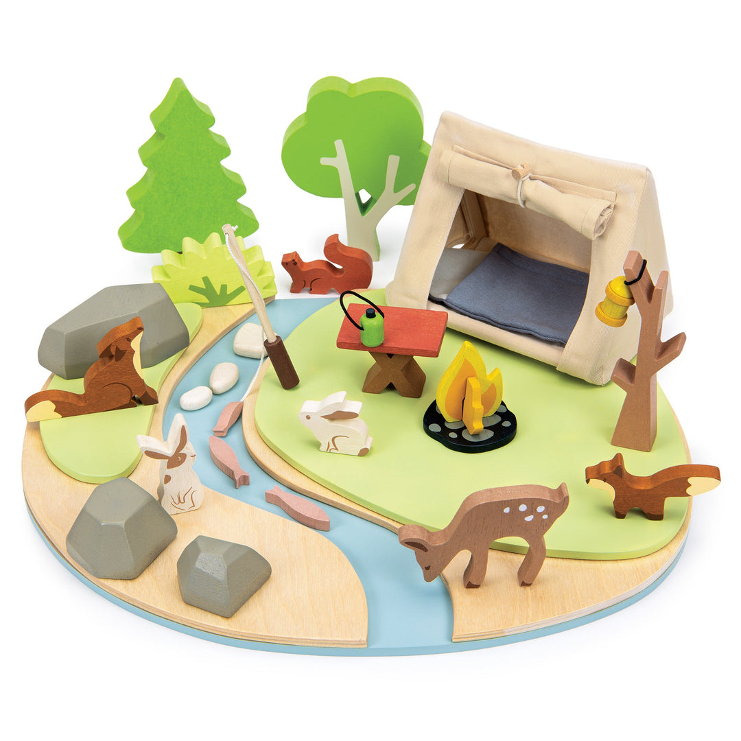 Wooden playset with a campsite, animals, and trees on a white background