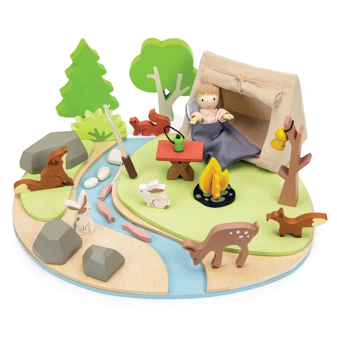 Toy camping scene with a child in a tent, animals, and nature elements on a white background