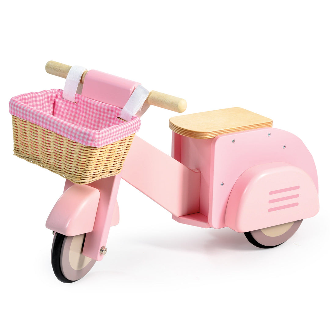 Pink children's scooter with a basket on a white background