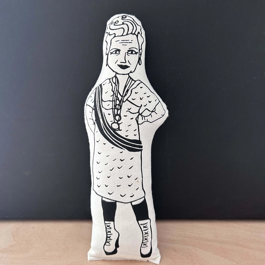 Screen printed black and white doll depicting Vivienne Westwood in a patterned dress with her hands on her hips