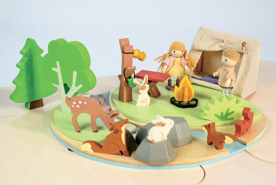 Wooden toy set with animals and people in a forest scene