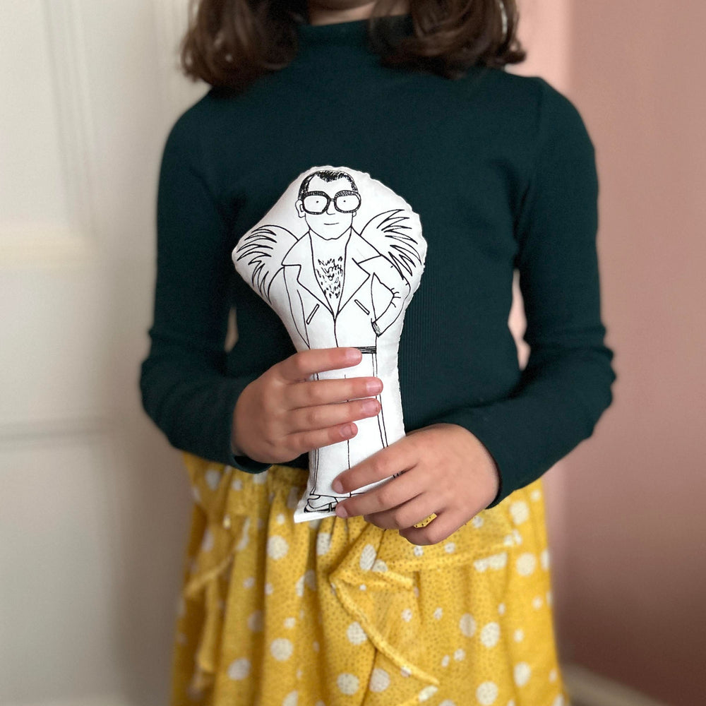 Child holding the Elton John doll in her hands
