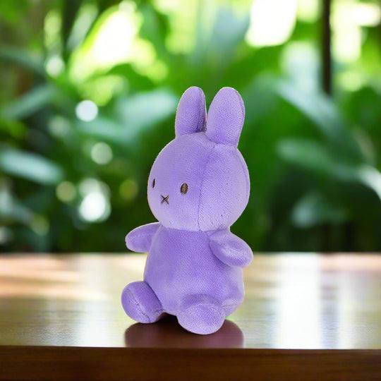 Purple plush stuffed toy rabbit angled to the left