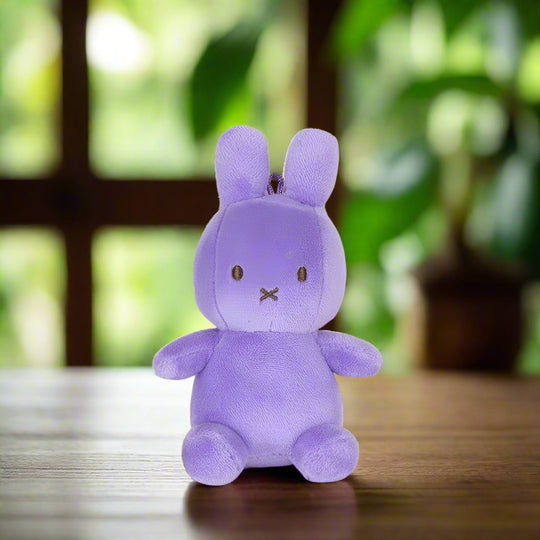 Purple plush stuffed toy rabbit out of gift box