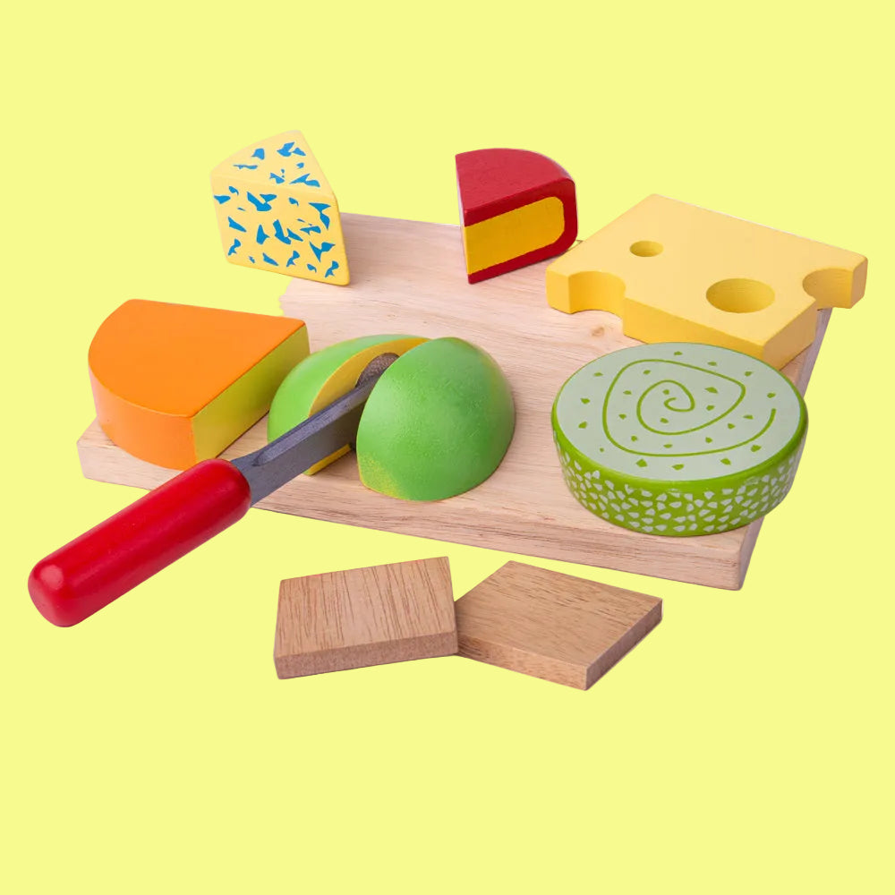 Wooden toy cheese set with a cutting board and tools on a white background