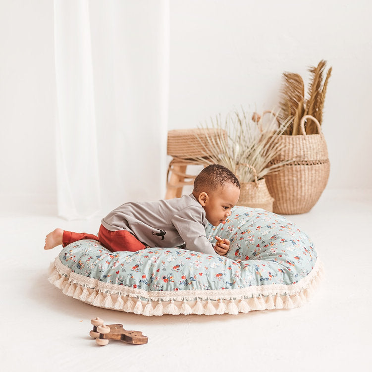 Child crawling across the floor cushion showing the plumpness and depth of it