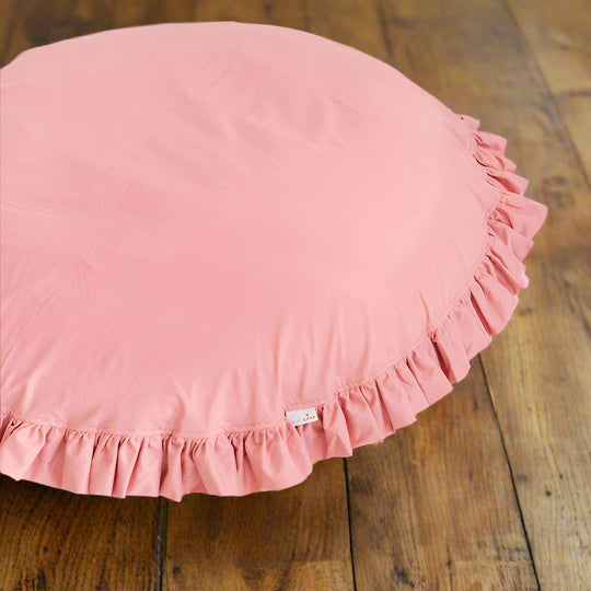 Pink round floor pillow with ruffled edge