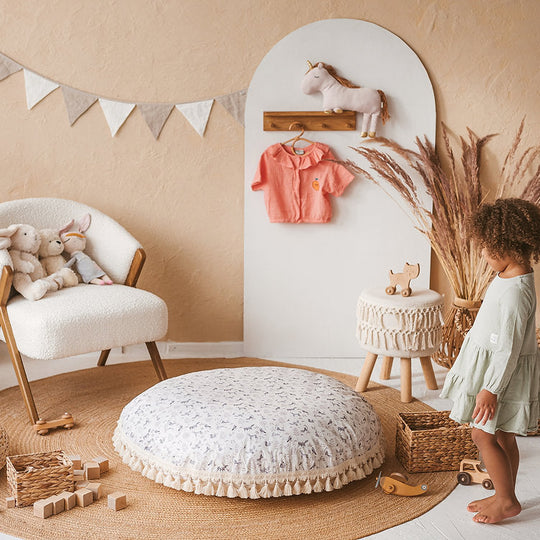 Children's playroom with toys, a child, and decorative elements.