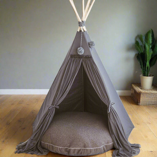 Grey play teepee with a matching grey floor cushion in a living room