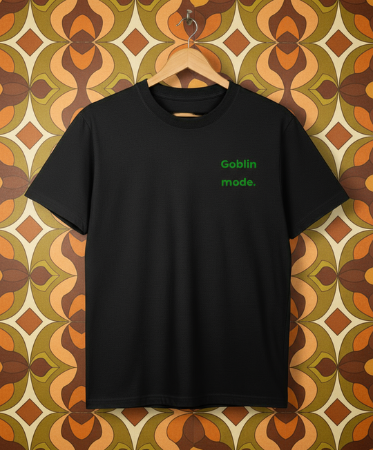 Black t-shirt with 'Goblin mode' text on a hanger against a white background