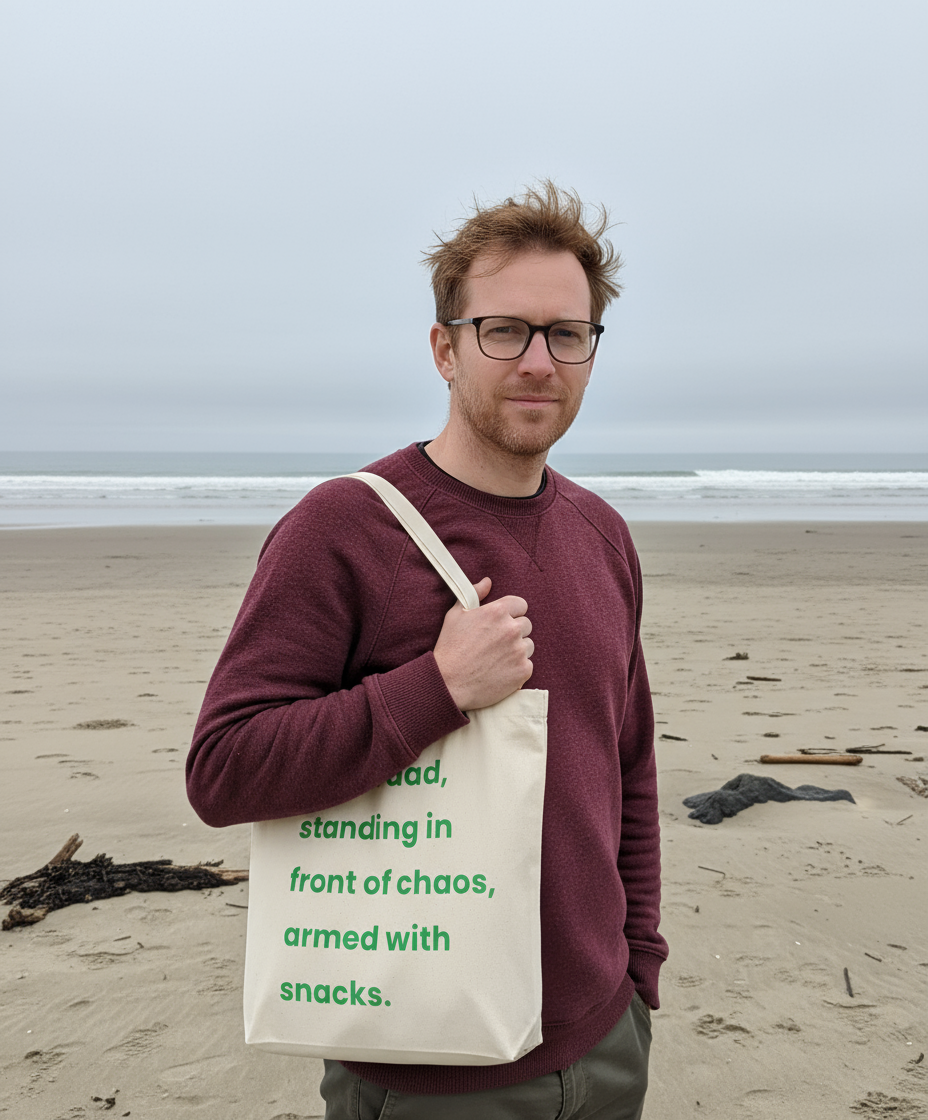 Man holding a tote bag with text on a beach