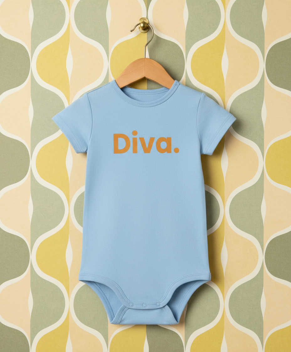 Blue baby onesie with 'Diva' text on a hanger against a patterned wall.