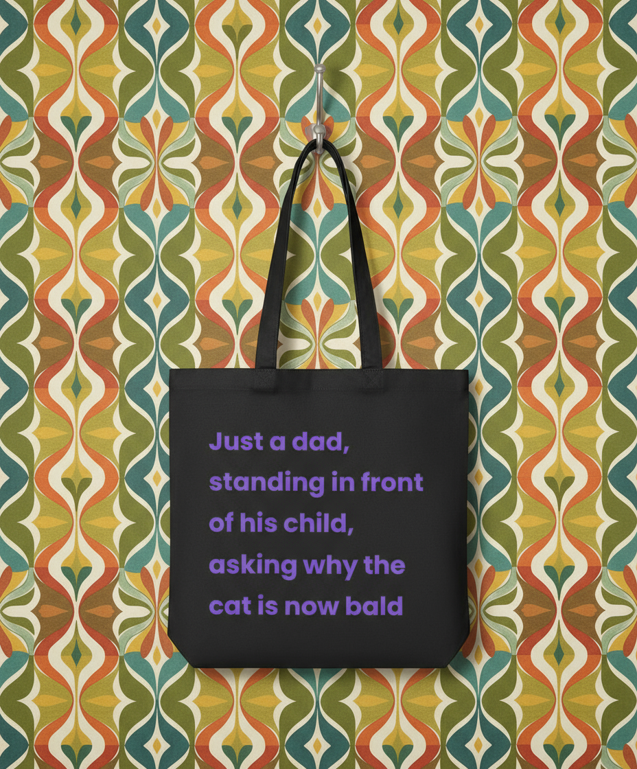 Black tote bag with purple text on a colourful patterned wall