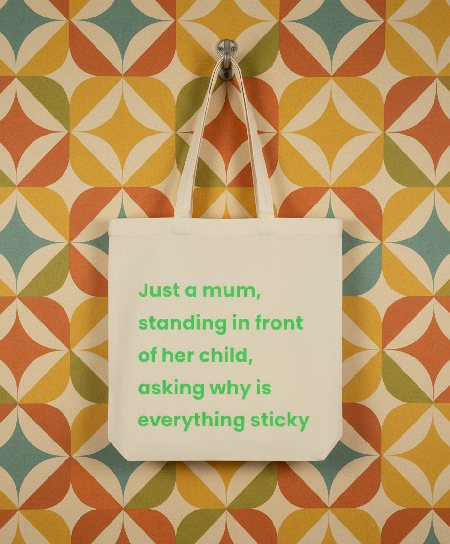 Tote bag with humorous text on a colorful geometric-patterned wall