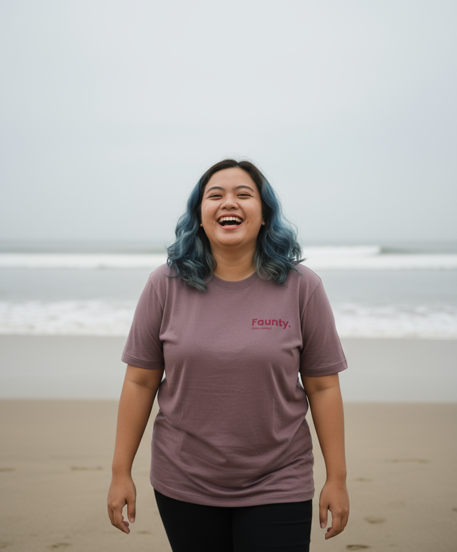 Person wearing a 'Faunty' t-shirt on a beach