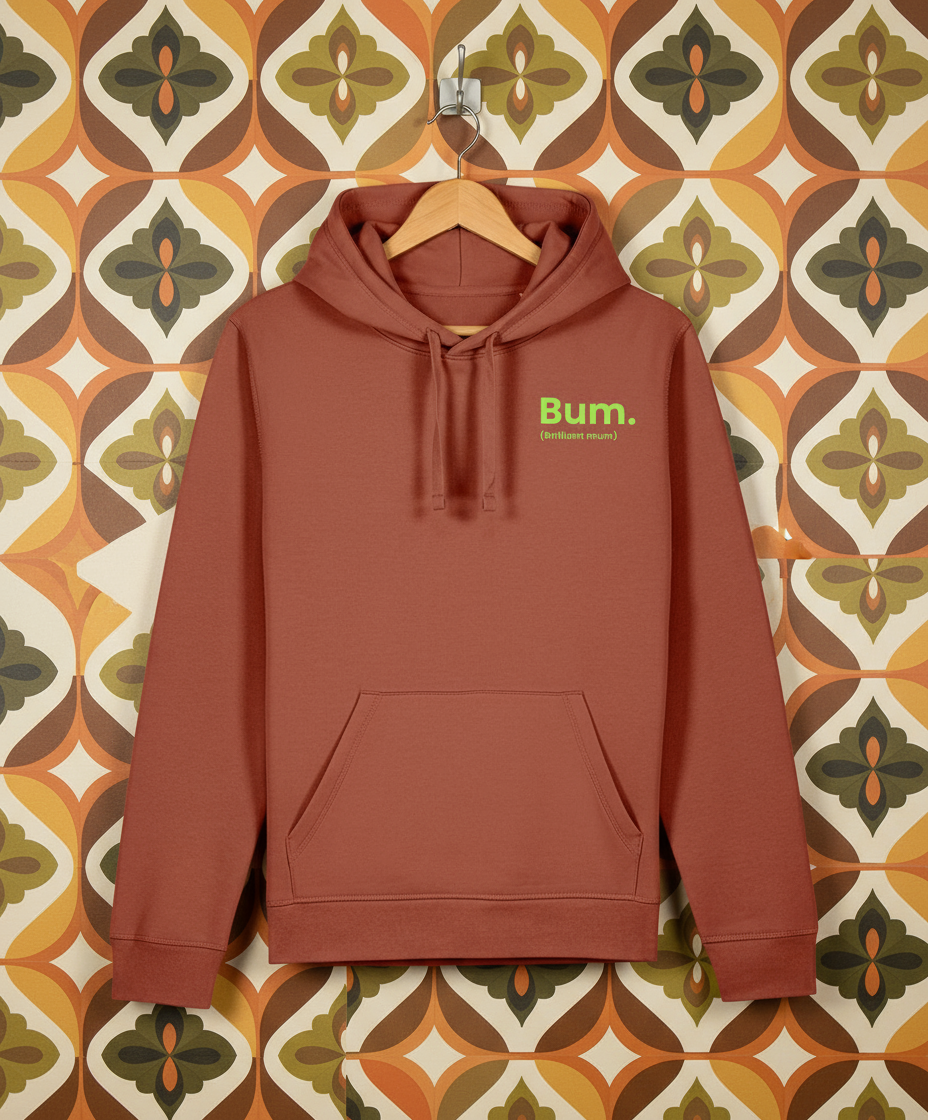 Brown hoodie with 'Bum' logo on a hanger against a patterned wall.