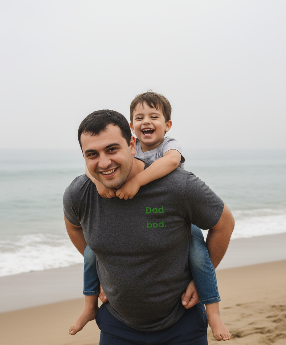 Man carrying a child on his shoulders at the beach