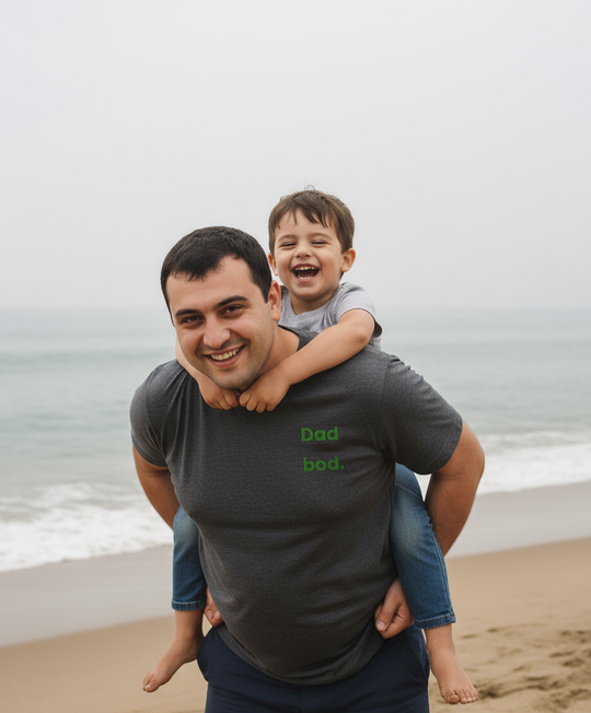 Man carrying a child on his shoulders at the beach