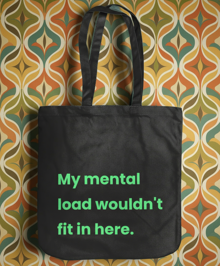 Black tote bag with green text on a patterned background
