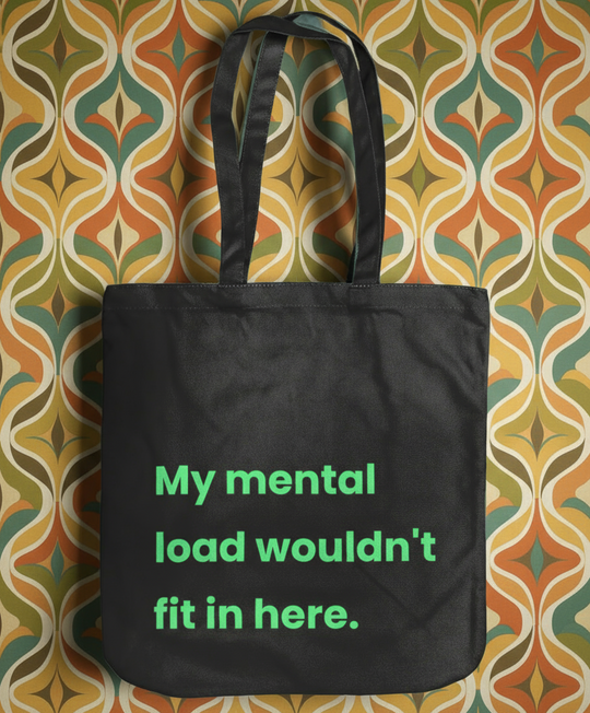Black tote bag with green text on a patterned background