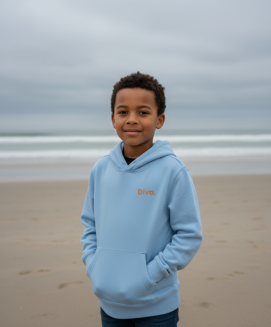 Child wearing a light blue hoodie with 'Dive' logo on a beach