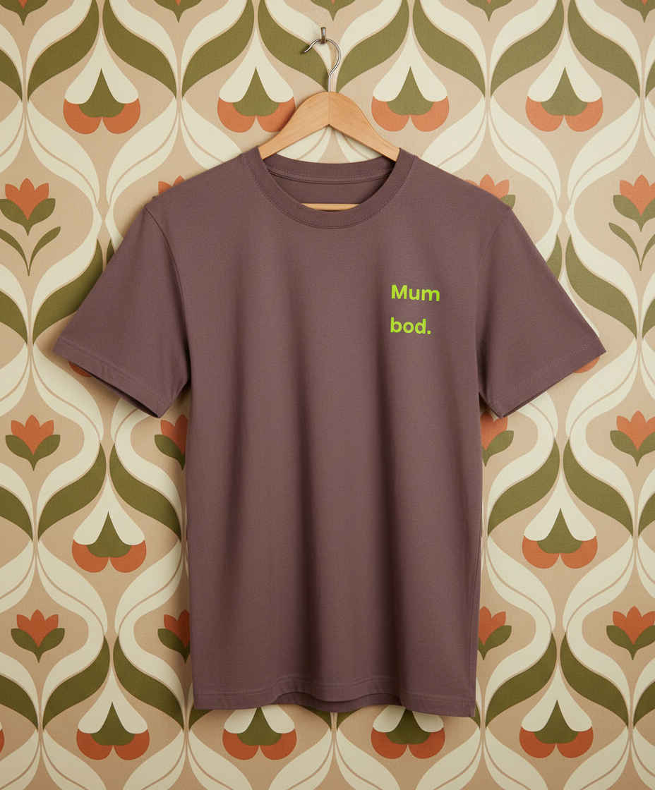 Brown t-shirt with 'Mum bod.' text on a patterned wall background