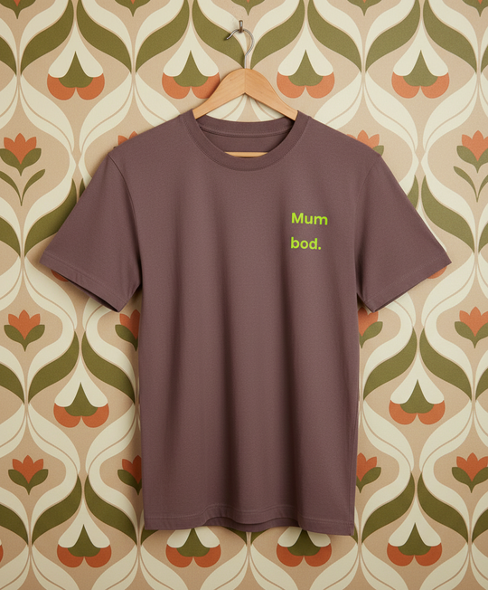 Brown t-shirt with 'Mum bod.' text on a patterned wall background