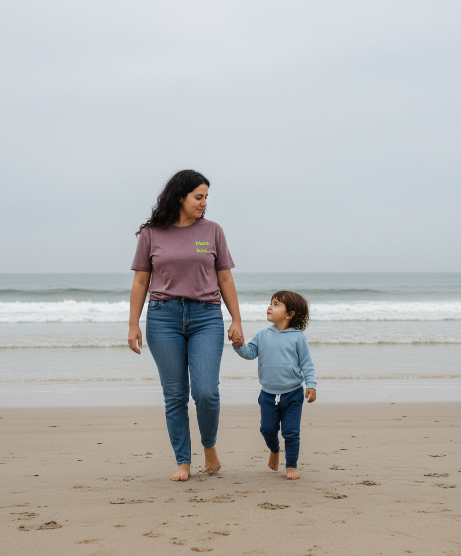 Woman and child walking on a beach holding hands