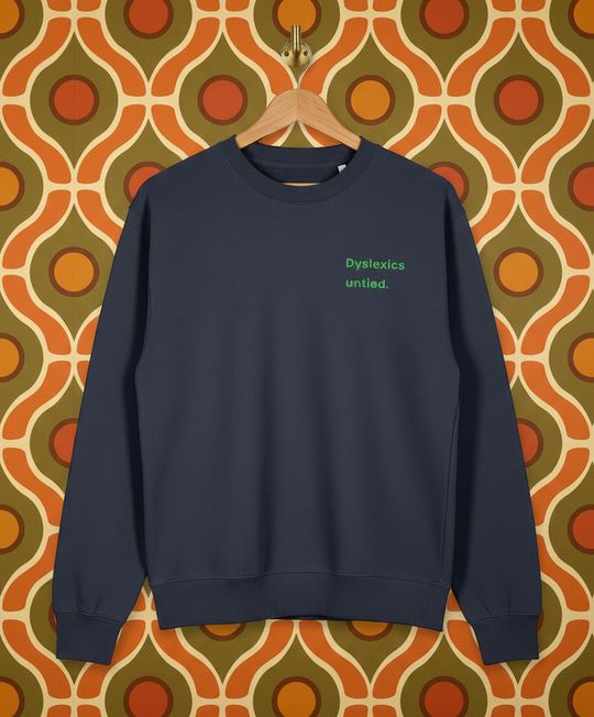 Navy blue sweatshirt with 'Dyslexics untied.' text on a patterned wall background