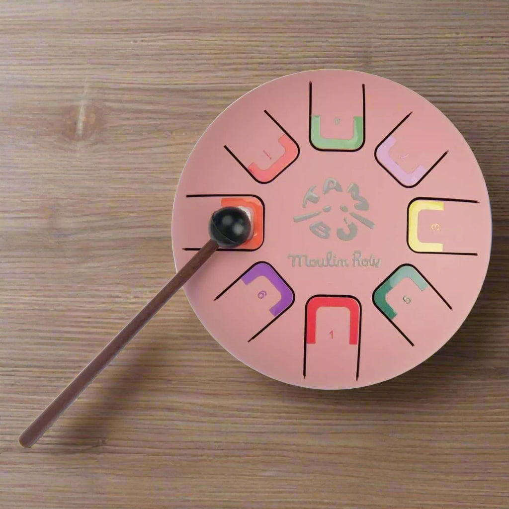 Pink musical instrument with colour-coded notes and a playing stick 
