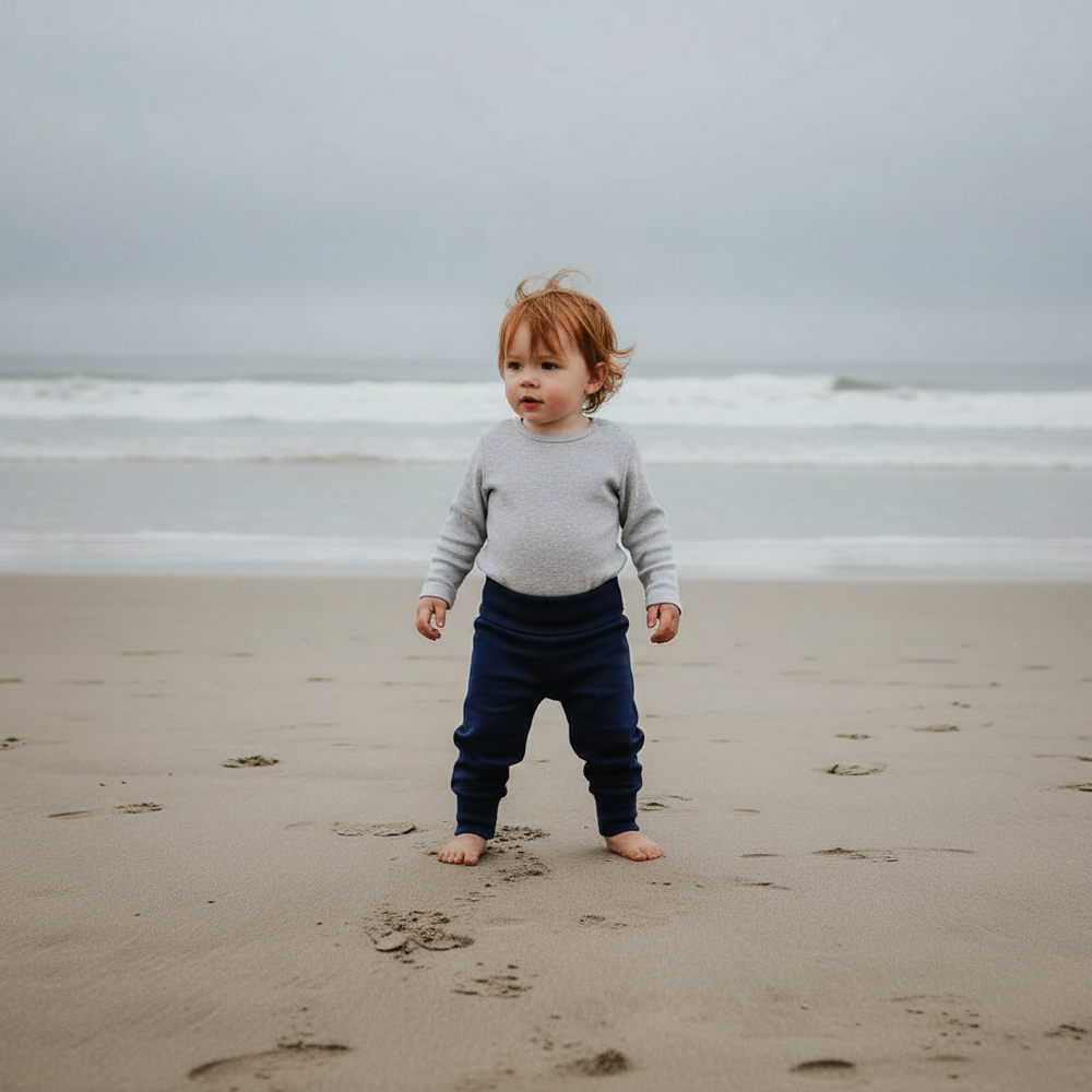 Navy blue baby pants on a light purple background