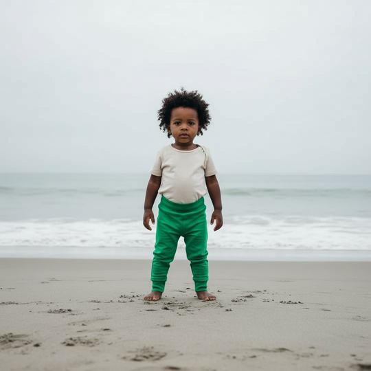 Green baby pants on a light green background